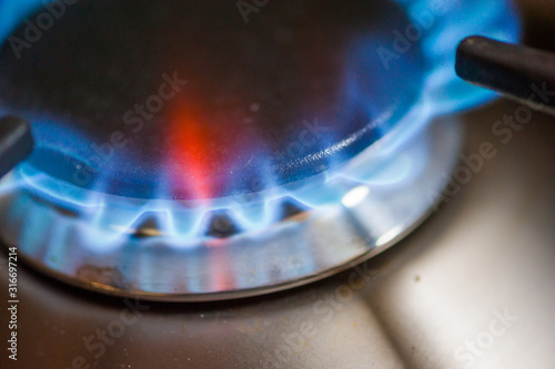 Gas flame from a stove close-up in a kitchen