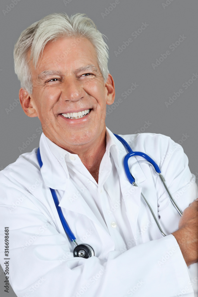 Portrait of happy senior male doctor over gray background Portrait of happy senior male doctor over gray background