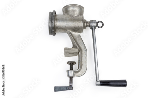 Old hand meat grinder on a white background © An-T