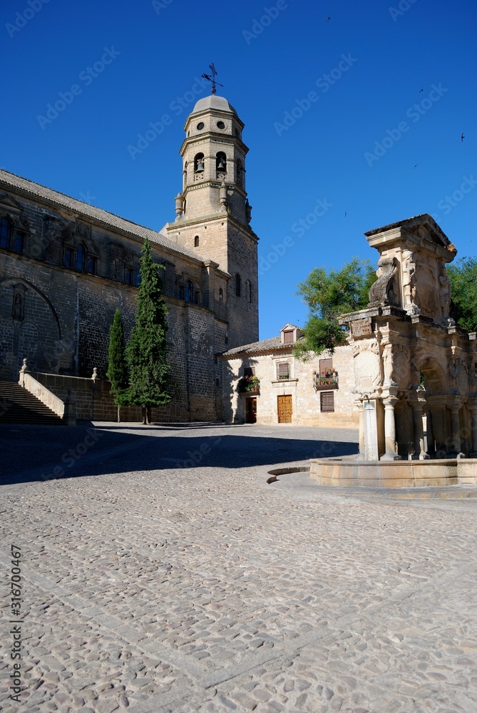 View of the Cathedral with the Santa Maria fountain to the right in the Santa Maria Plaza, Baeza, Spain.