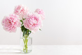 Lovely flowers in glass vase. Beautiful bouquet of pink peonies. Floral composition, copy space. Wallpaper, greeting card, poster, floral shop concept
