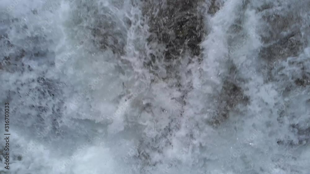 Rapid mountain river stream close up. Rushing mountain river flowing over rocks close up. Abstract water background. Rapid mountain river stream close up. Rushing mountain river flowing over rocks close up. Abstract water background.