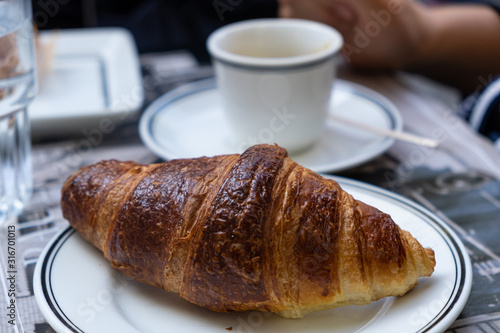 Εκτύπωση καμβά A well-done croissant on white dish in close up view