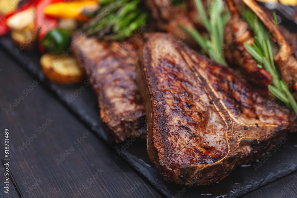 grilled set of steaks, t-bone and vegetables