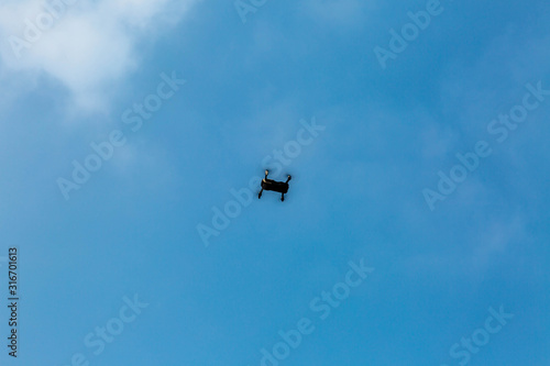 quadrocopter in the blue sky with clouds