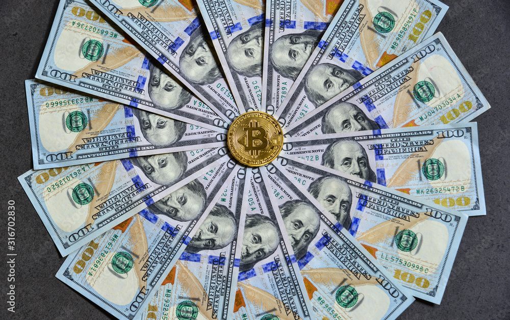 Golden bitcoin on USD 100 billnotes