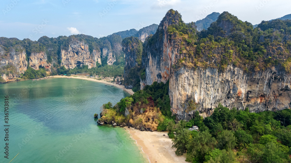 Railay beach in Thailand, Krabi province, aerial bird's view of tropical Railay and Pranang beaches with rocks and palm trees, coastline of Andaman sea from above