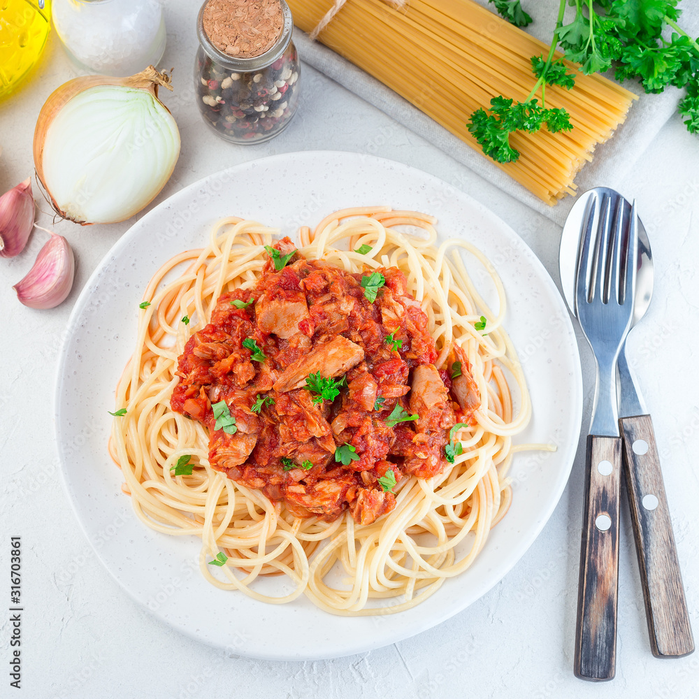 Spaghetti with tuna and tomato basil sauce garnished with parsley, square Spaghetti with tuna and tomato basil sauce garnished with parsley, square