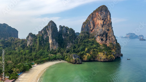 Railay beach in Thailand  Krabi province  aerial bird s view of tropical Railay and Pranang beaches with rocks and palm trees  coastline of Andaman sea from above