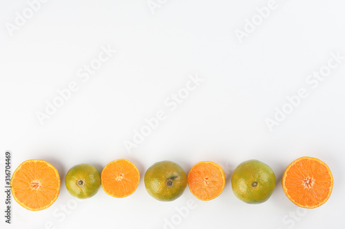 small yellow green mandarin orange whole slice on white background copy space for text frame border