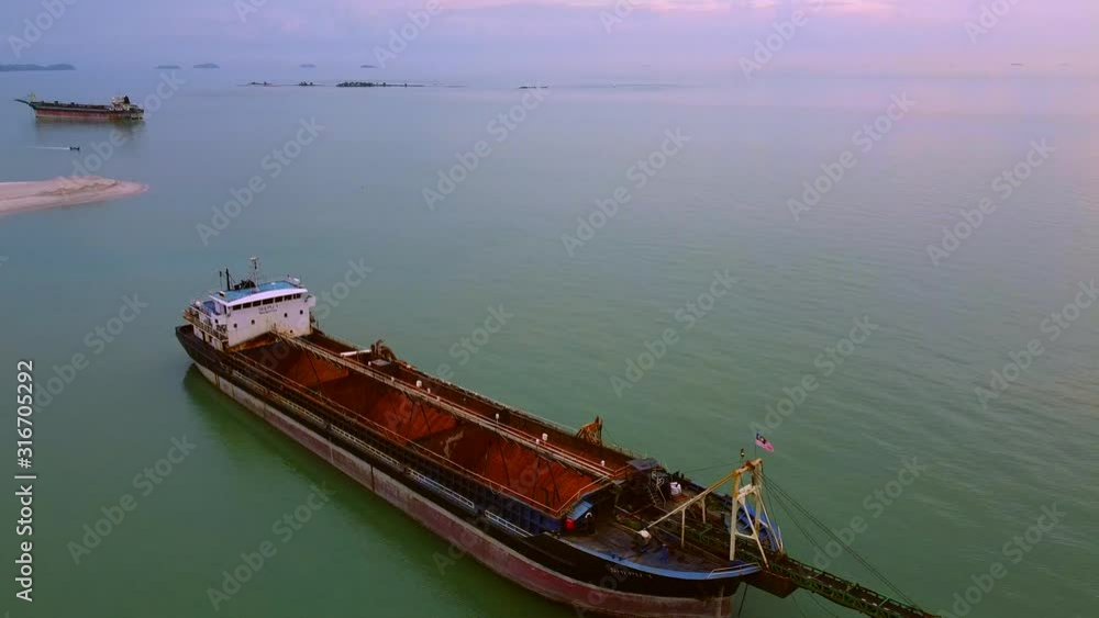 Drone flying over a huge cargo ship in the strait of Melaka Drone flying over a huge cargo ship in the strait of Melaka