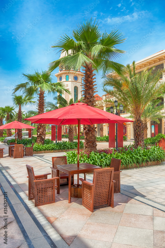 Fototapeta premium The sitting area with sunshades and tables in a small street park,Fuzhou,Fujian,China