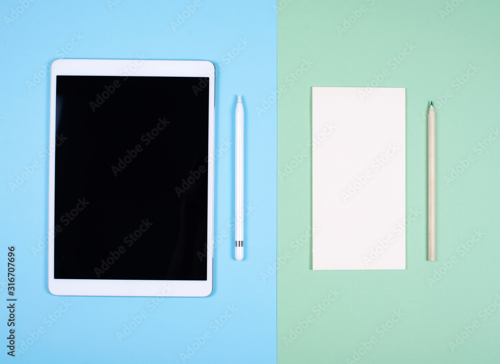Modern tablet and a paper Notepad with a pencil. The concept of a digital detox. Modern tablet and a paper Notepad with a pencil. The concept of a digital detox.