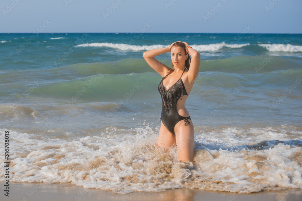 Plus size nice young woman with full hips and pretty figure in black swimsuit with fringe rest at sea, vacation and trip concept Plus size nice young woman with full hips and pretty figure in black swimsuit with fringe rest at sea, vacation and trip concept