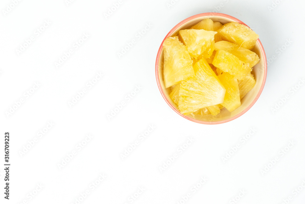 Pineapple in a bowl on the table top view background Pineapple in a bowl on the table top view background