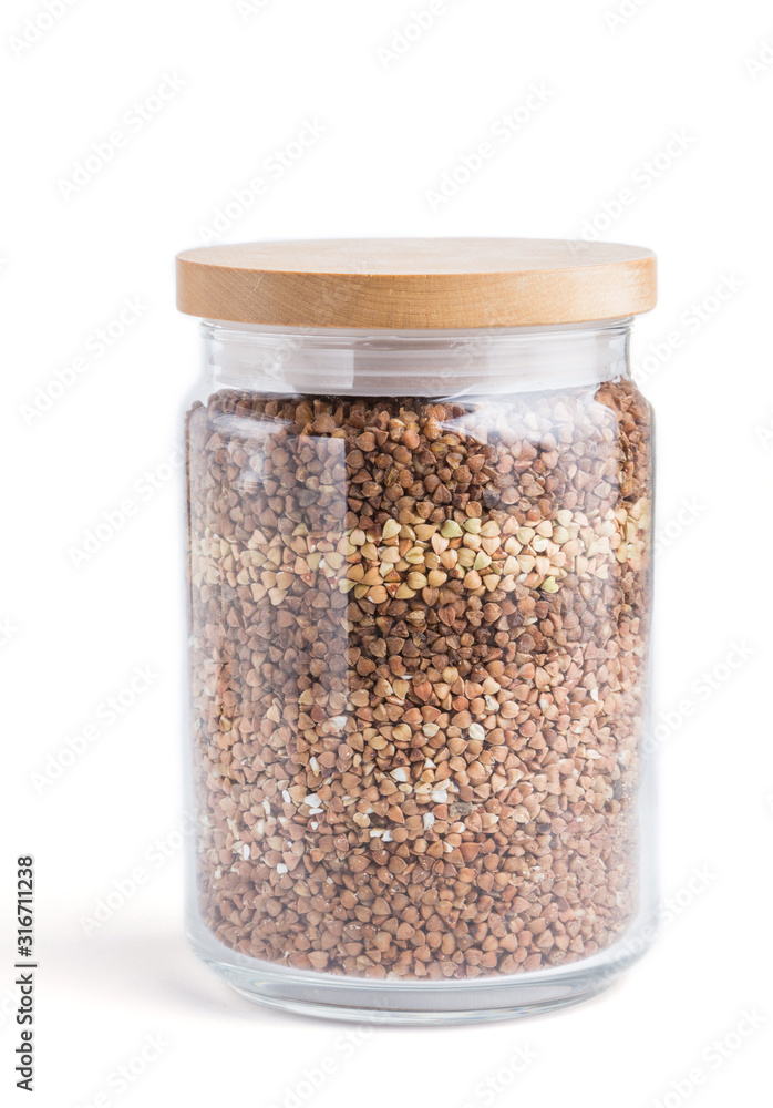 glass jar with buckwheat poured in layers isolated on white background. side view glass jar with buckwheat poured in layers isolated on white background. side view