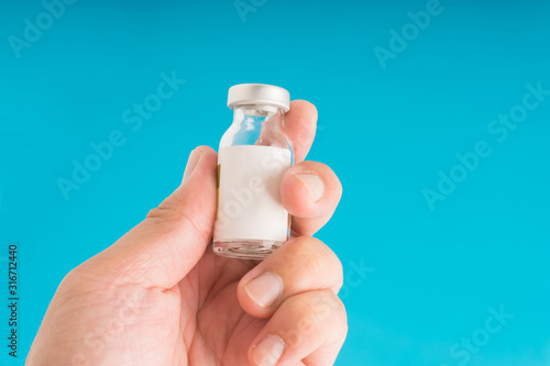 Hand holding medication vial mock up.
