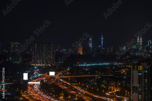 Night view of Kuala Lumpur city with busy traffic jam on the highway.;