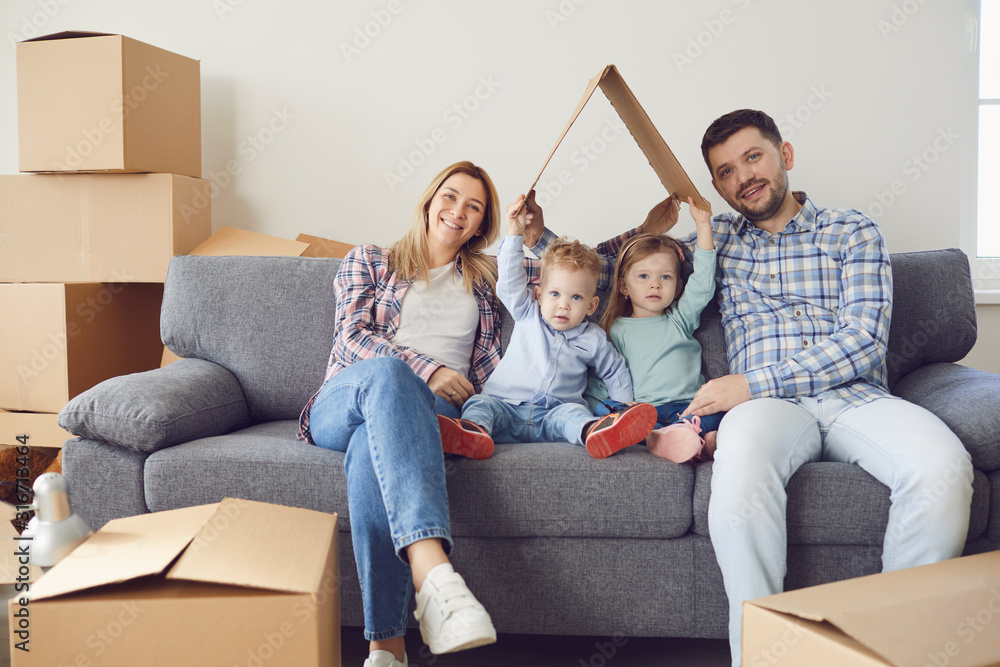 Happy family smiling at a new house moving. Happy family smiling at a new house moving.