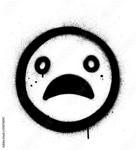 graffiti sad face icon sprayed in black over white