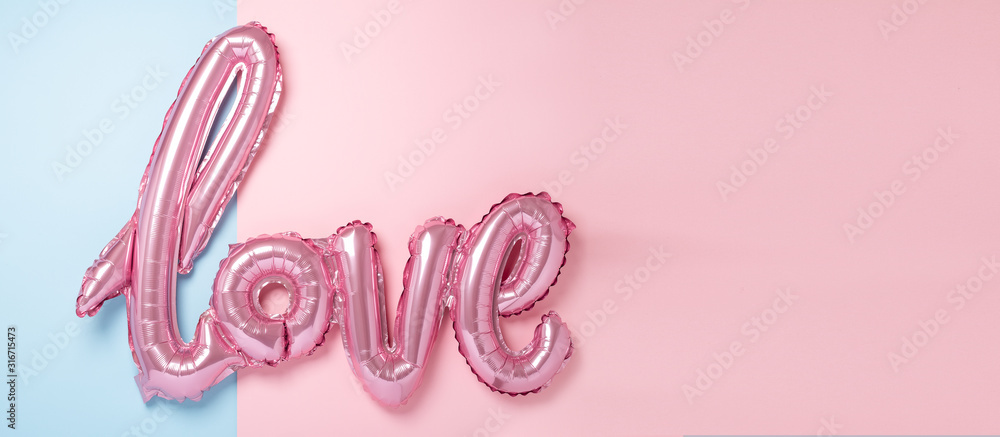 Pink balloons in the form of word Love on pink and blue background. Valentines day celebration. Horizontal banner