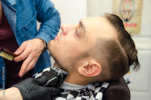 male haircut on a white background. Male hairdresser.