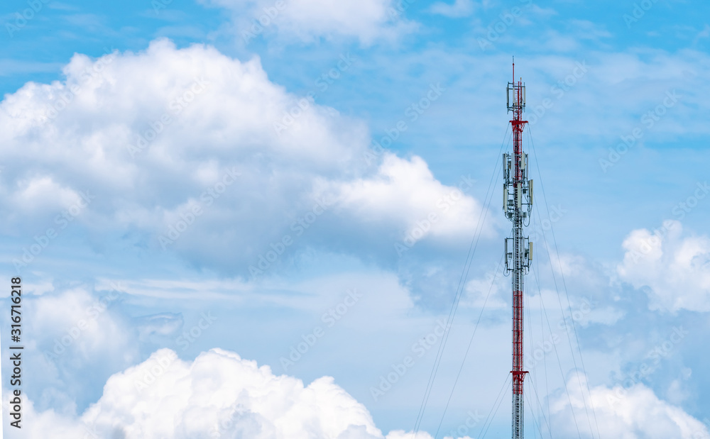 Telecommunication tower with blue sky and white clouds background. Antenna on blue sky. Radio and satellite pole. Communication technology. Telecommunication industry. Mobile or telecom 4g network. Telecommunication tower with blue sky and white clouds background. Antenna on blue sky. Radio and satellite pole. Communication technology. Telecommunication industry. Mobile or telecom 4g network.