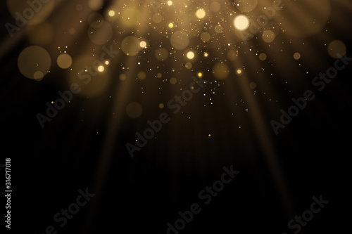 Golden flash of light with glares bokeh on a black background. Rays of light with glitter. Vector illustration