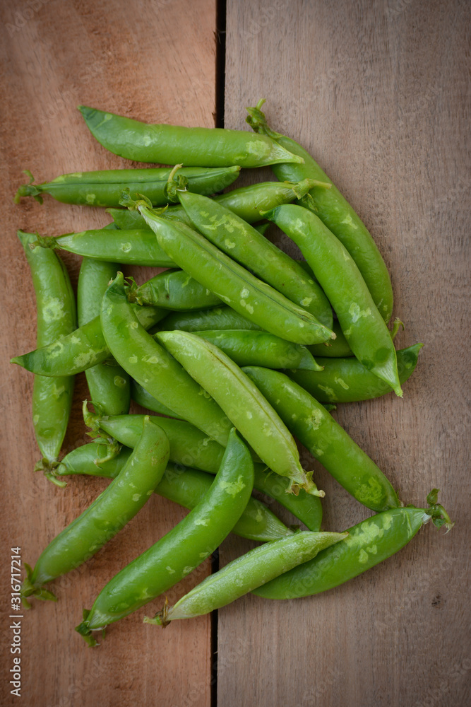 Fresh green peas on wooden background Fresh green peas on wooden background