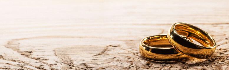 Golden wedding rings on wood
