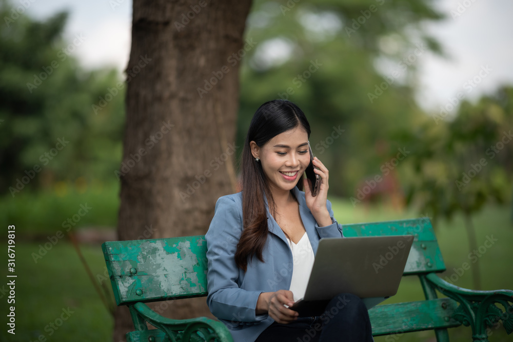 businesswomen working with laptop in the garden morning with coffee cup businesswomen working with laptop in the garden morning with coffee cup