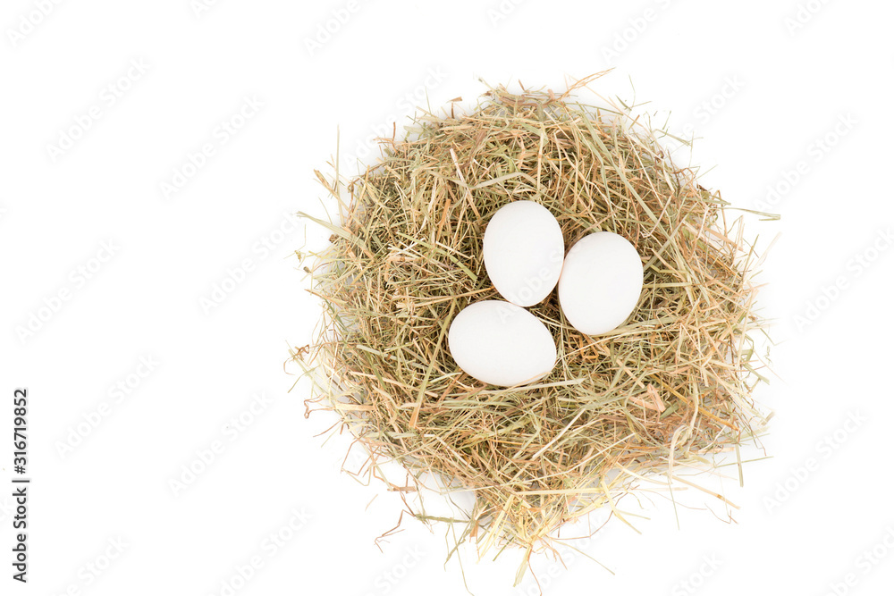 Eggs in a hay nest isolated on a white background Eggs in a hay nest isolated on a white background
