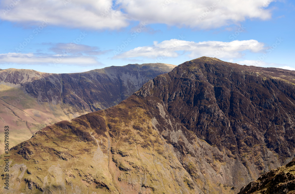 The mountain ridge leading to the summit of Fleetwith Pike with views of Dale Head in the distance in the English Lake District.