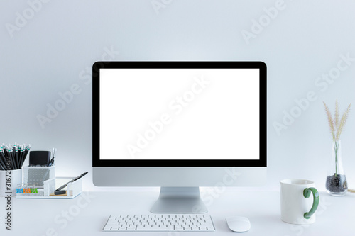 Computer with blank white copy space for text, Mockup design desktop computer in office on white table with keyboard and Coffee cub, Work place concept.