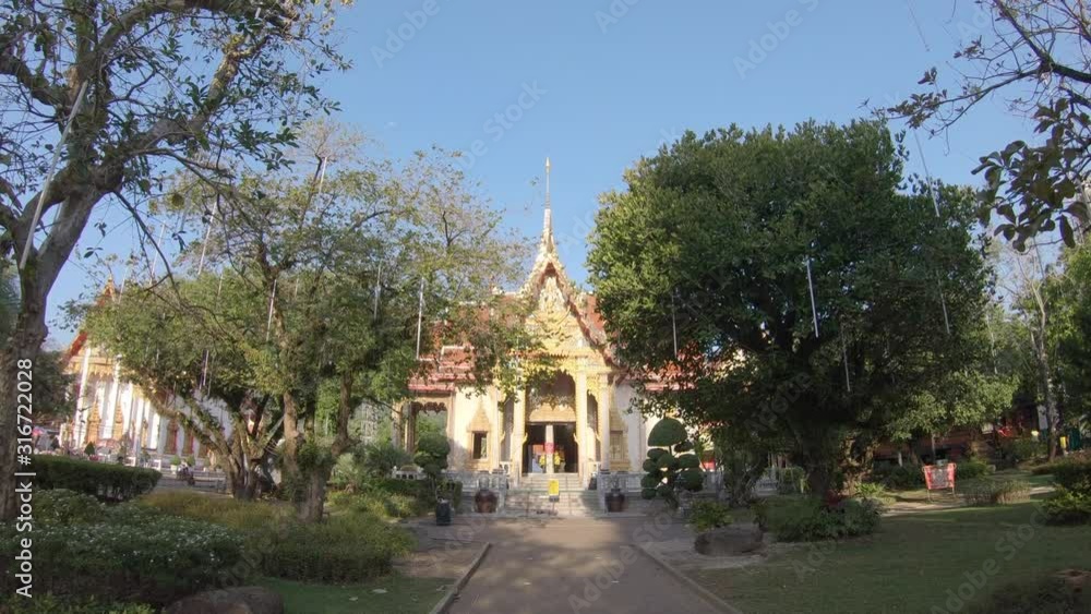 Camera moves on the path with temple on the background Camera moves on the path with temple on the background