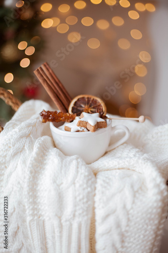 wicker basket, knitted sweater, dried citruses, cinnamon sticks, Christmas cookies, Christmas lights. Cozy.