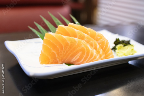 Fresh salmon sashimi serve on plate. Japanese food style.