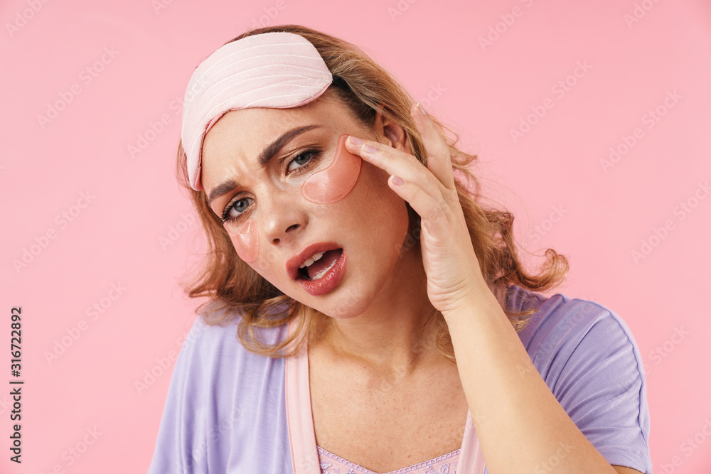 Image of caucasian displeased woman applying eye patches Image of caucasian displeased woman applying eye patches