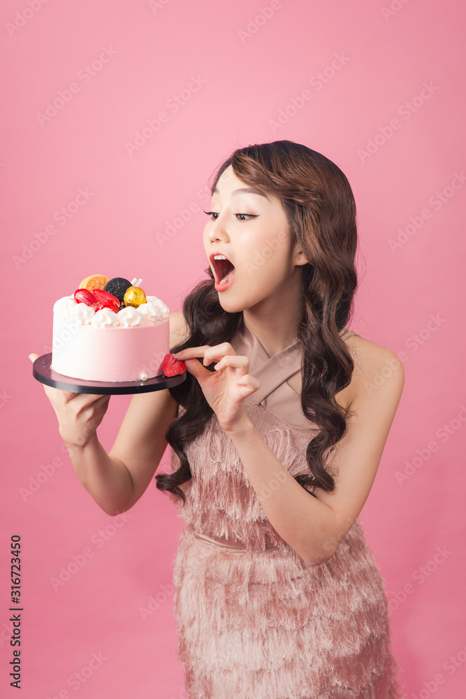 Generous woman holding birthday cake front pink background Generous woman holding birthday cake front pink background