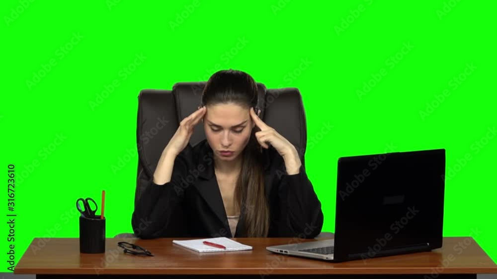 Pretty woman sits at the workplace with a notebook and pencil, thinks hard, sighs irritably and rolls her eyes. Green screen. Slow motion Pretty woman sits at the workplace with a notebook and pencil, thinks hard, sighs irritably and rolls her eyes. Green screen. Slow motion