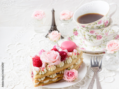 Romantic Valentine s Day breakfast. Sweet dessert - a piece of cake with macaroons and roses.