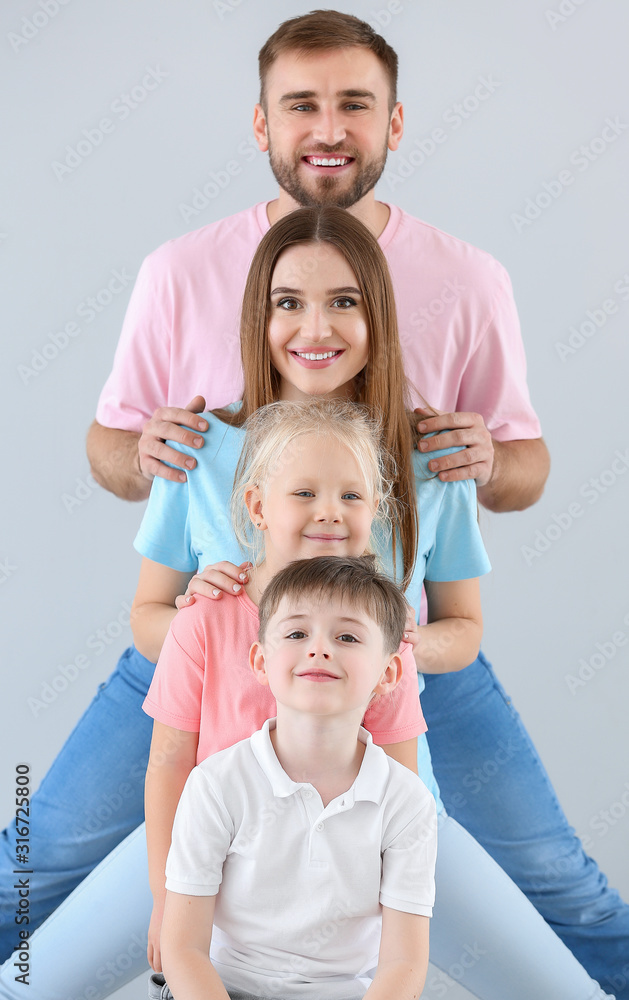 Portrait of happy family on light background