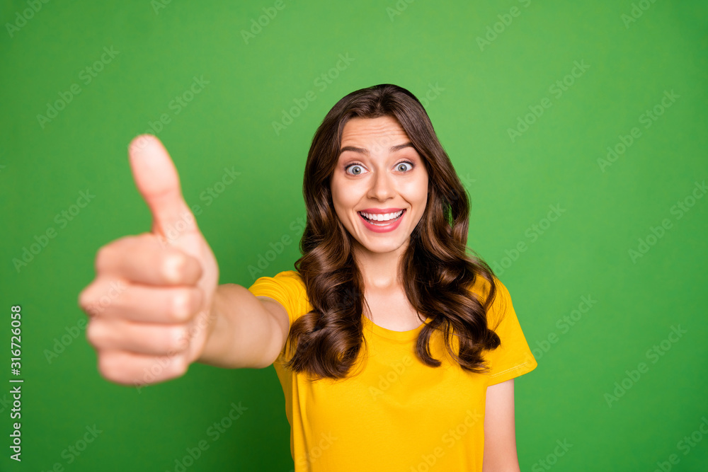 Close-up portrait of her she nice attractive lovely pretty charming cheerful cheery wavy-haired girl giving you thumbup ad advert isolated over bright vivid shine vibrant green color background Close-up portrait of her she nice attractive lovely pretty charming cheerful cheery wavy-haired girl giving you thumbup ad advert isolated over bright vivid shine vibrant green color background