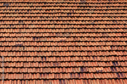 Texture of new tiled roof with brown color, close-up