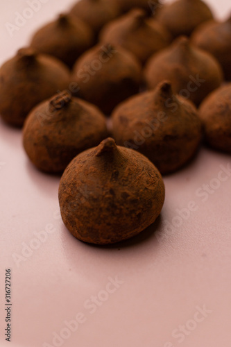 Chocolate truffles in dark background with copy space.