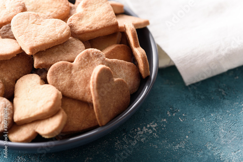 cookies hearts on plate on blue background with white cloth towel photo