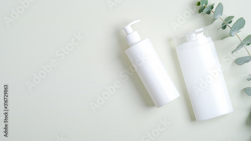 Cosmetics SPA branding mockup. Bath shampoo or shower gel bottle, hair lotion and eucalyptus leaves. Bath beauty products packaging, natural organic SPA treatment concept