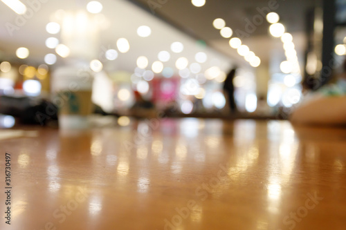 wooden table empty of display in cafe with luxury light decoration