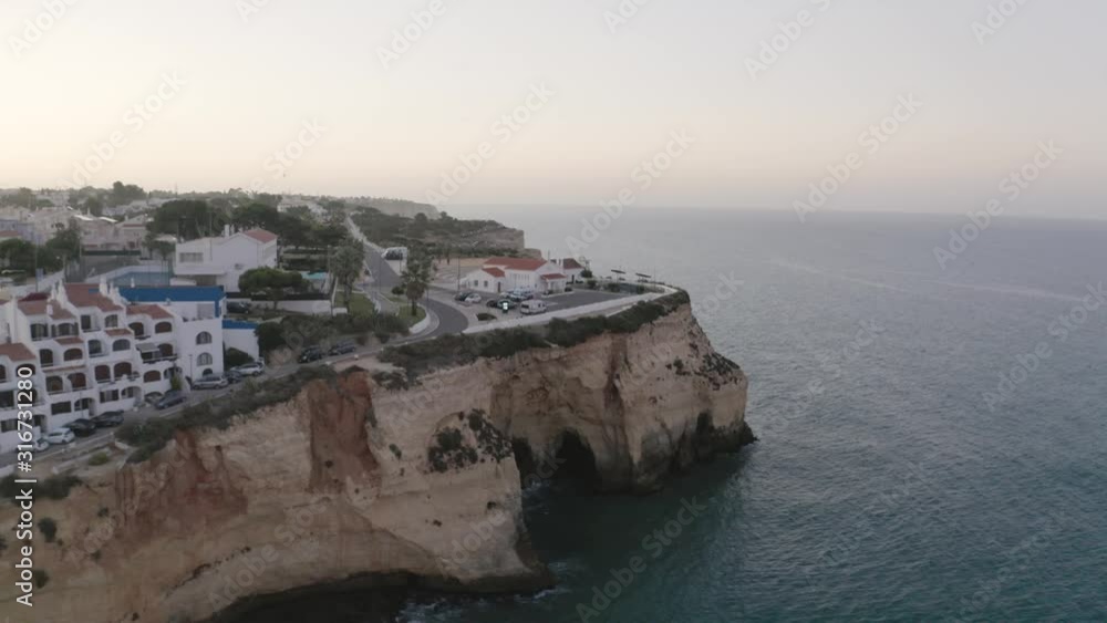 AERIAL : Algarve, Carvoeiro cliffs with a beautiful sunrise at the ocean! AERIAL : Algarve, Carvoeiro cliffs with a beautiful sunrise at the ocean!