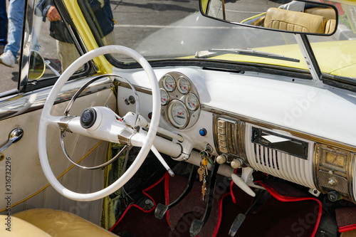 interior of a yellow cuban convertible classic car, steering wheel, cuba 